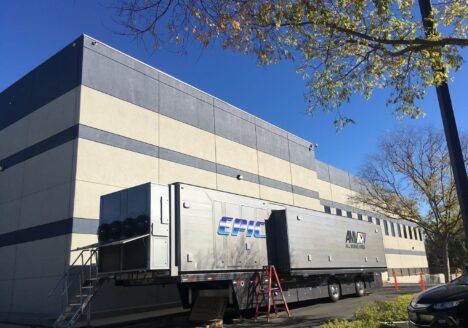 Mobile television video truck parked outside professional sound stage.