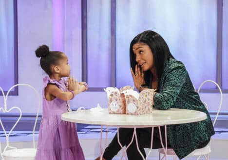 Tiffany Haddish sits at table with child and talks about cookies.