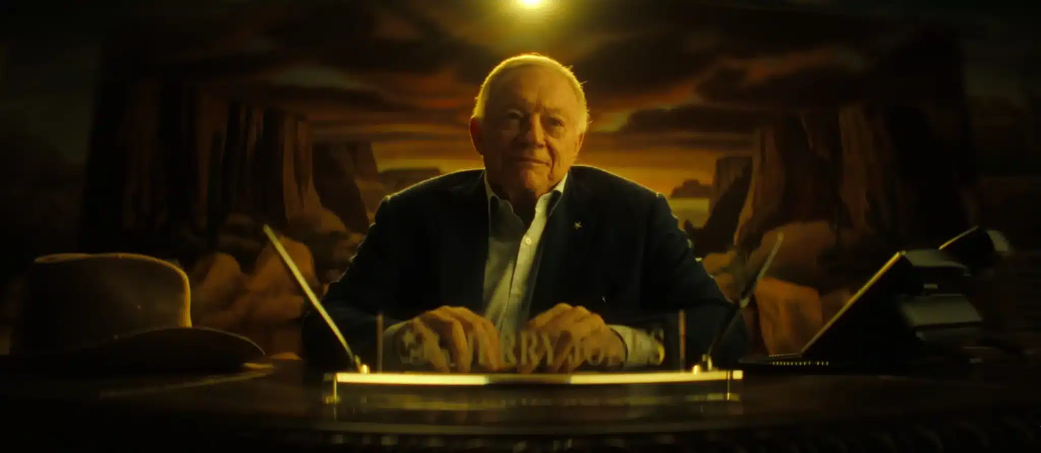 Jerry Jones sits at desk for Netflix documentary.